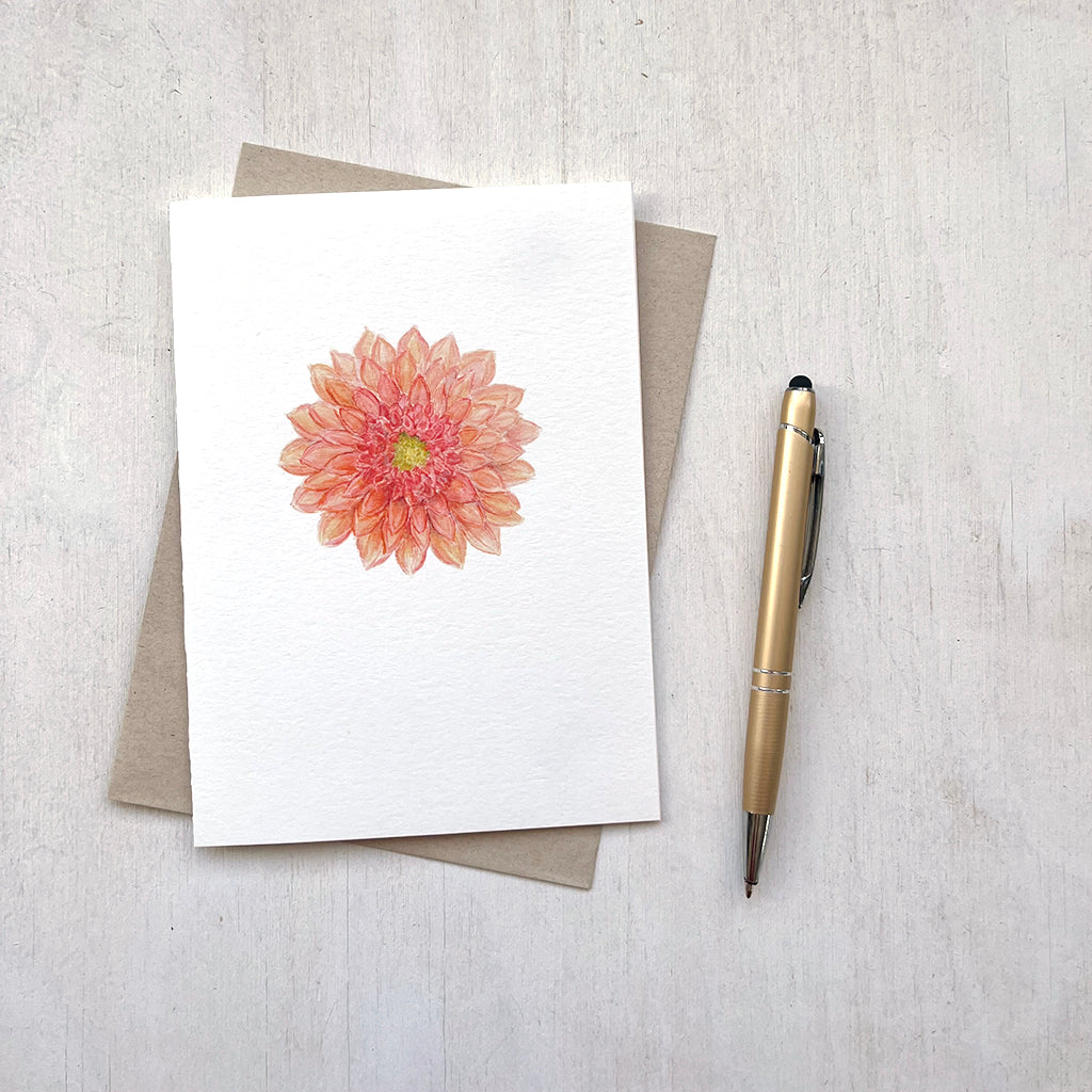 A beautiful orange-red dahlia flower is featured on this watercolour note card by Canadian artist Kathleen Maunder.