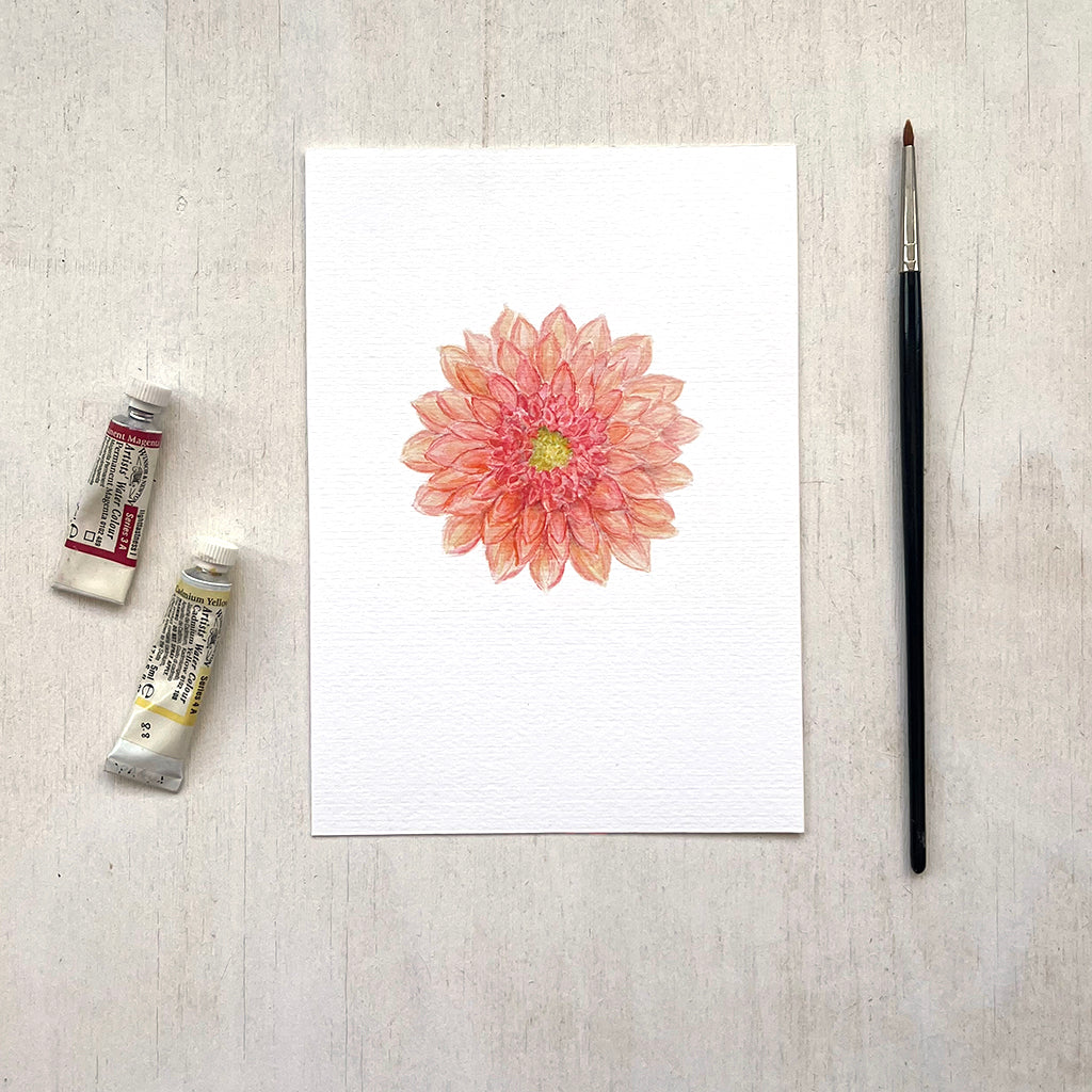 A detailed and delicate watercolour art print of an orange-red dahlia. Artist Kathleen Maunder.