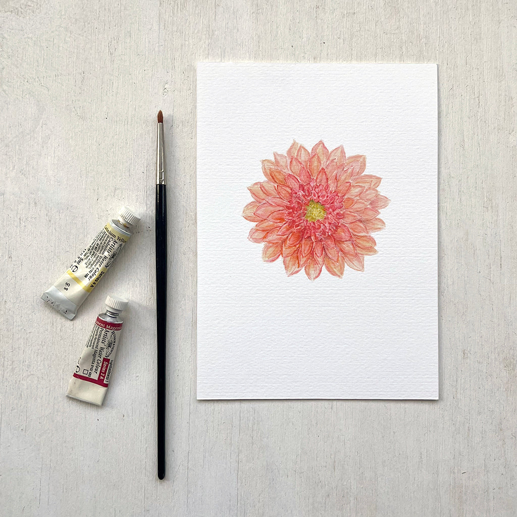 A detailed and delicate watercolour painting of a coral-coloured dahlia offered as a 5 x 7 inch print. Artist Kathleen Maunder.