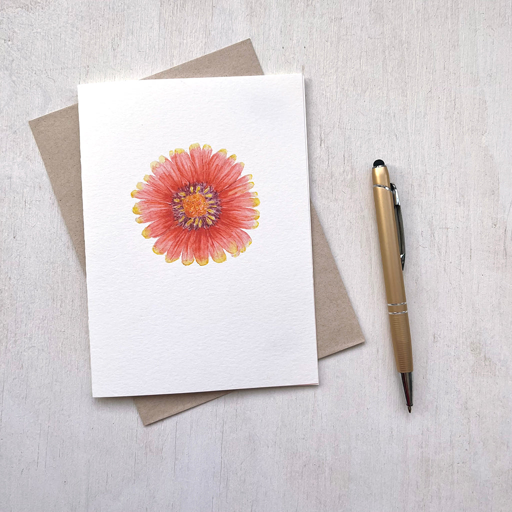 A note card with a watercolour painting of a red and yellow blanket flower (gaillardia). Artist Kathleen Maunder.