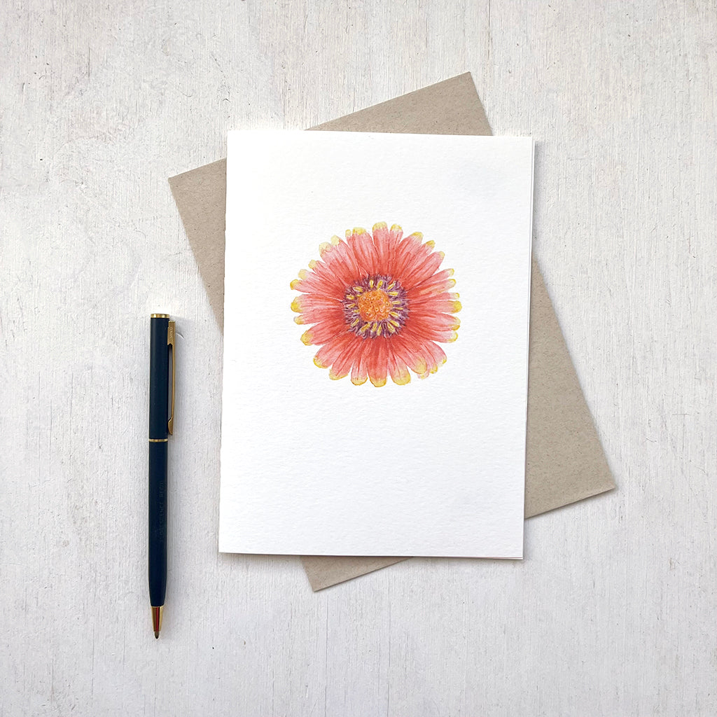 A note card featuring a red and yellow gaillardia flower with its accompanying recycled envelope. Watercolour painting by Kathleen Maunder.