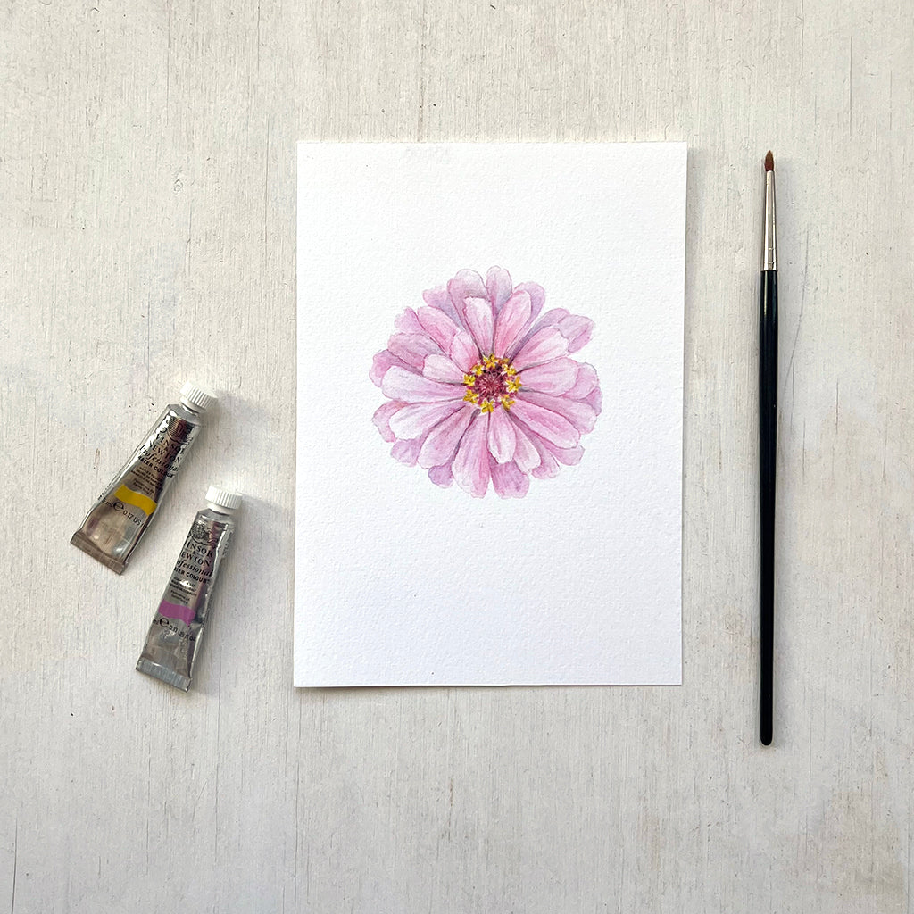 A 5 x7 inch art print of a beautiful pink zinnia painted in watercolour by artist Kathleen Maunder.